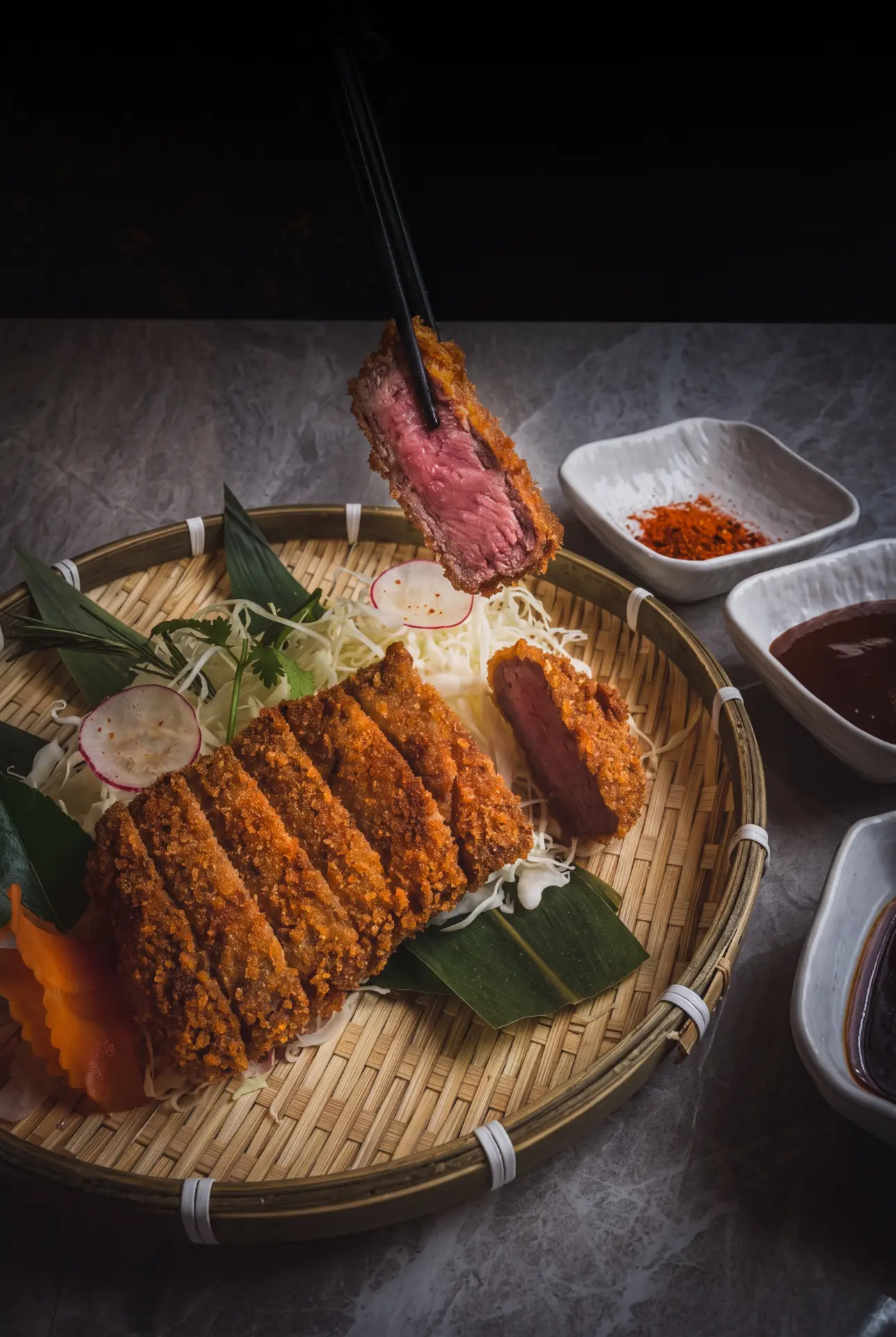 Sliced beef katsu resting on a bamboo tray