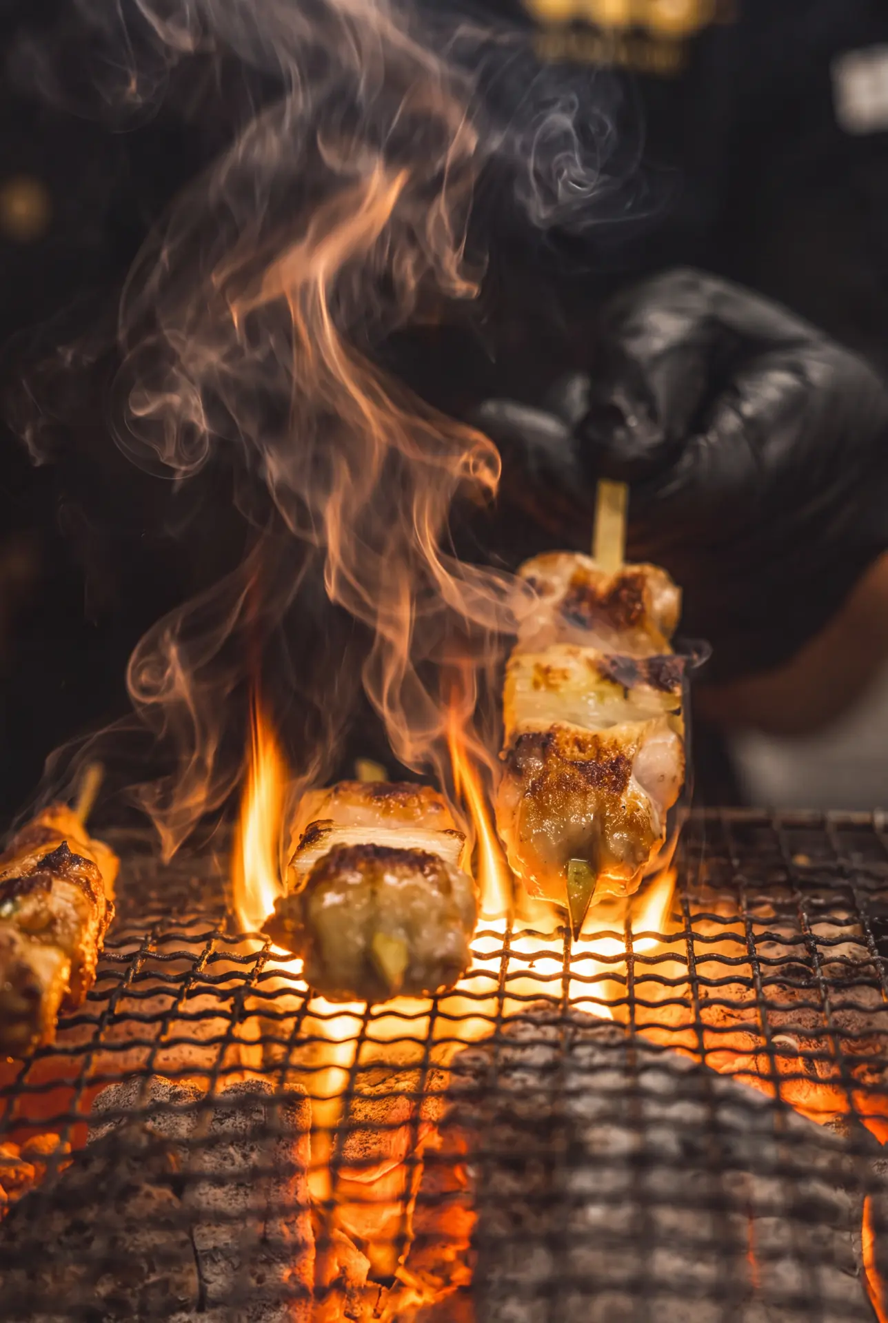 Yakitori kissed by flames over glowing binchotan charcoal